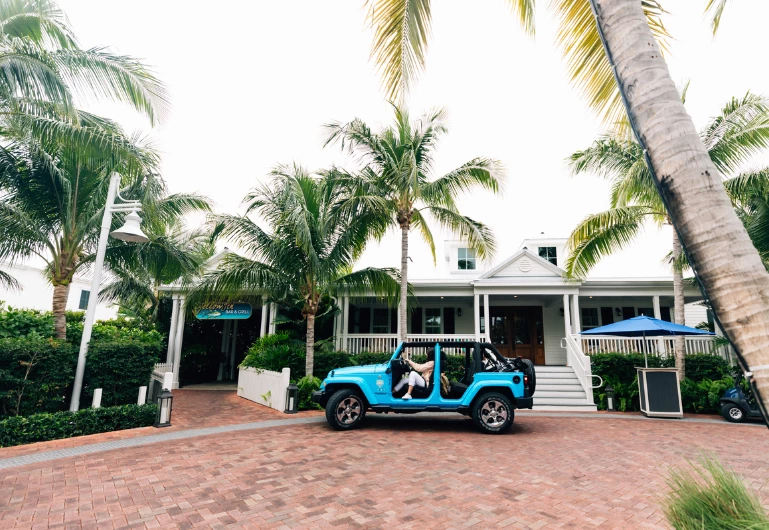 a blue jeep with people in it