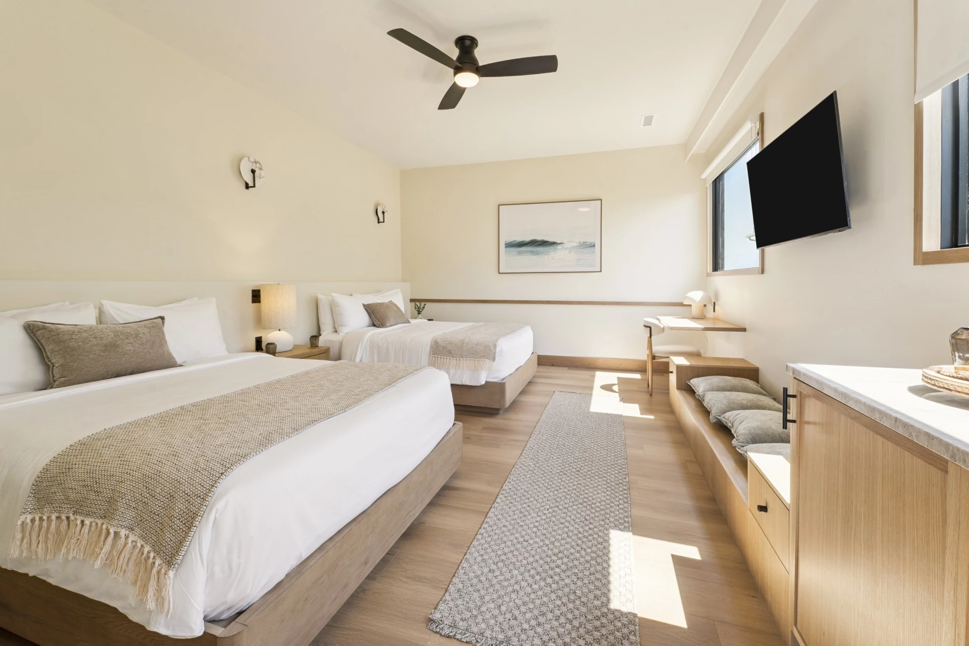 a room with two beds and a tv