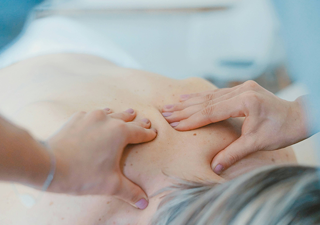 a person receiving a back massage