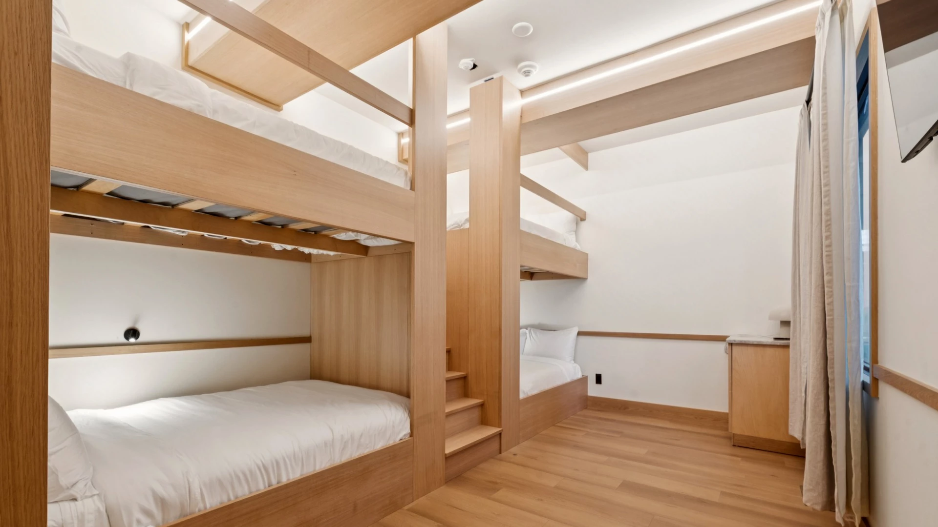 a room with bunk beds and stairs