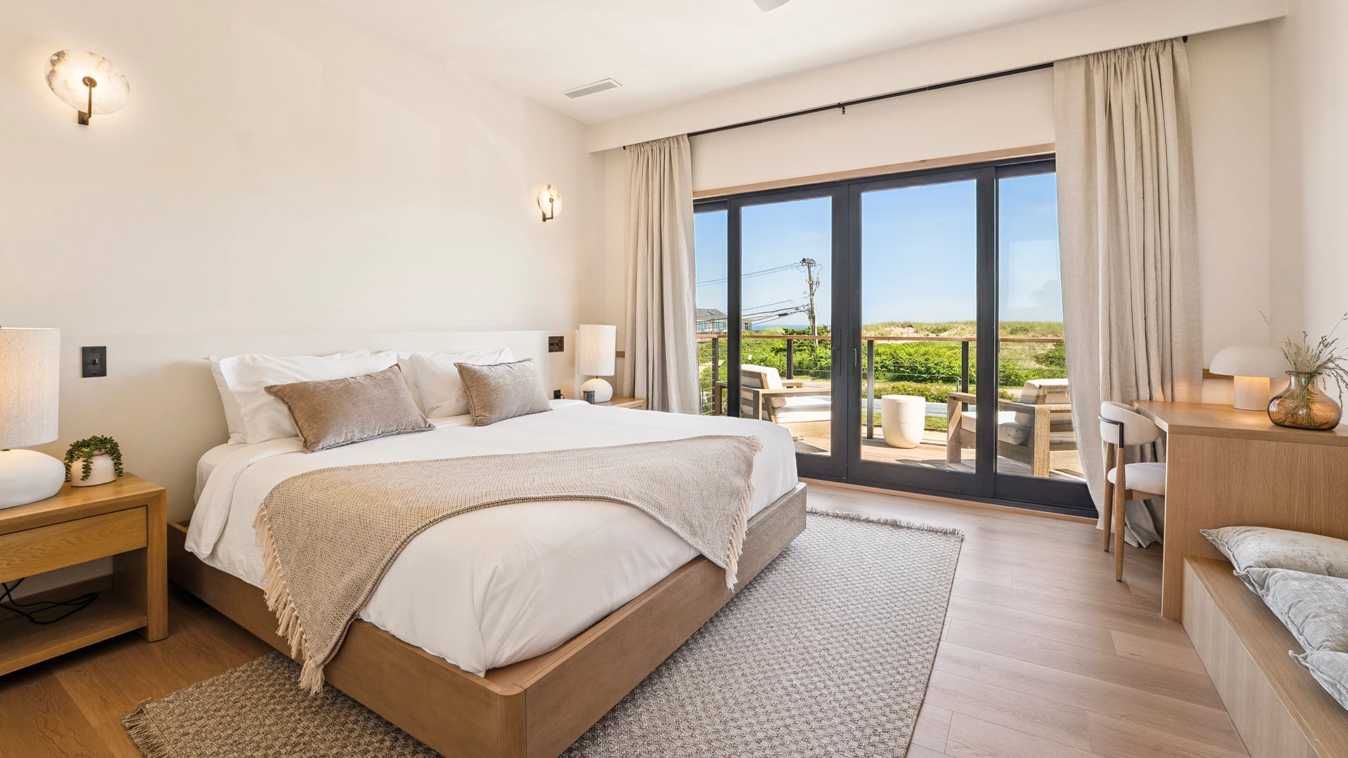 a bedroom with a large bed and glass doors