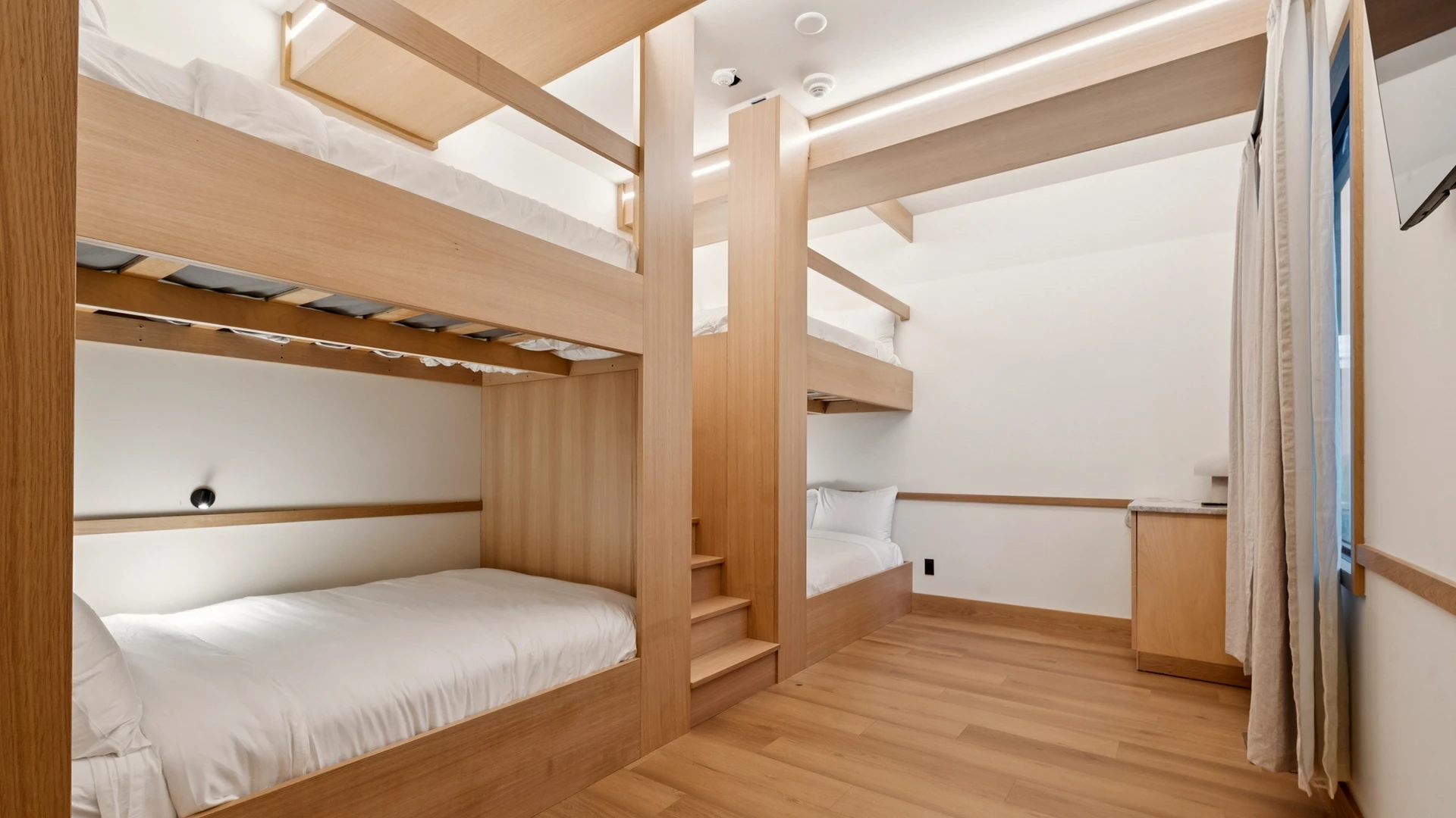 a room with bunk beds and stairs