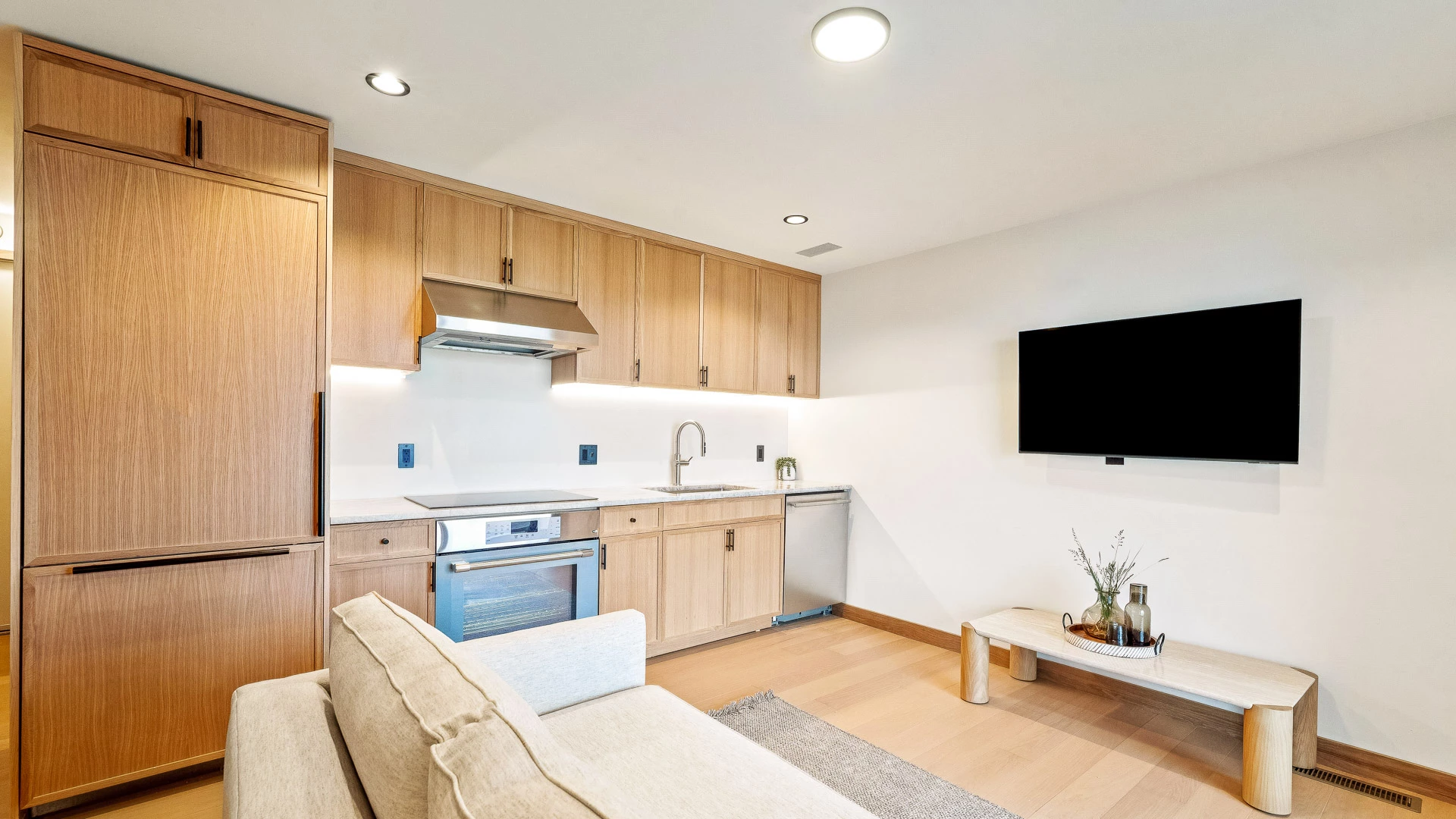 a kitchen with a couch and a television