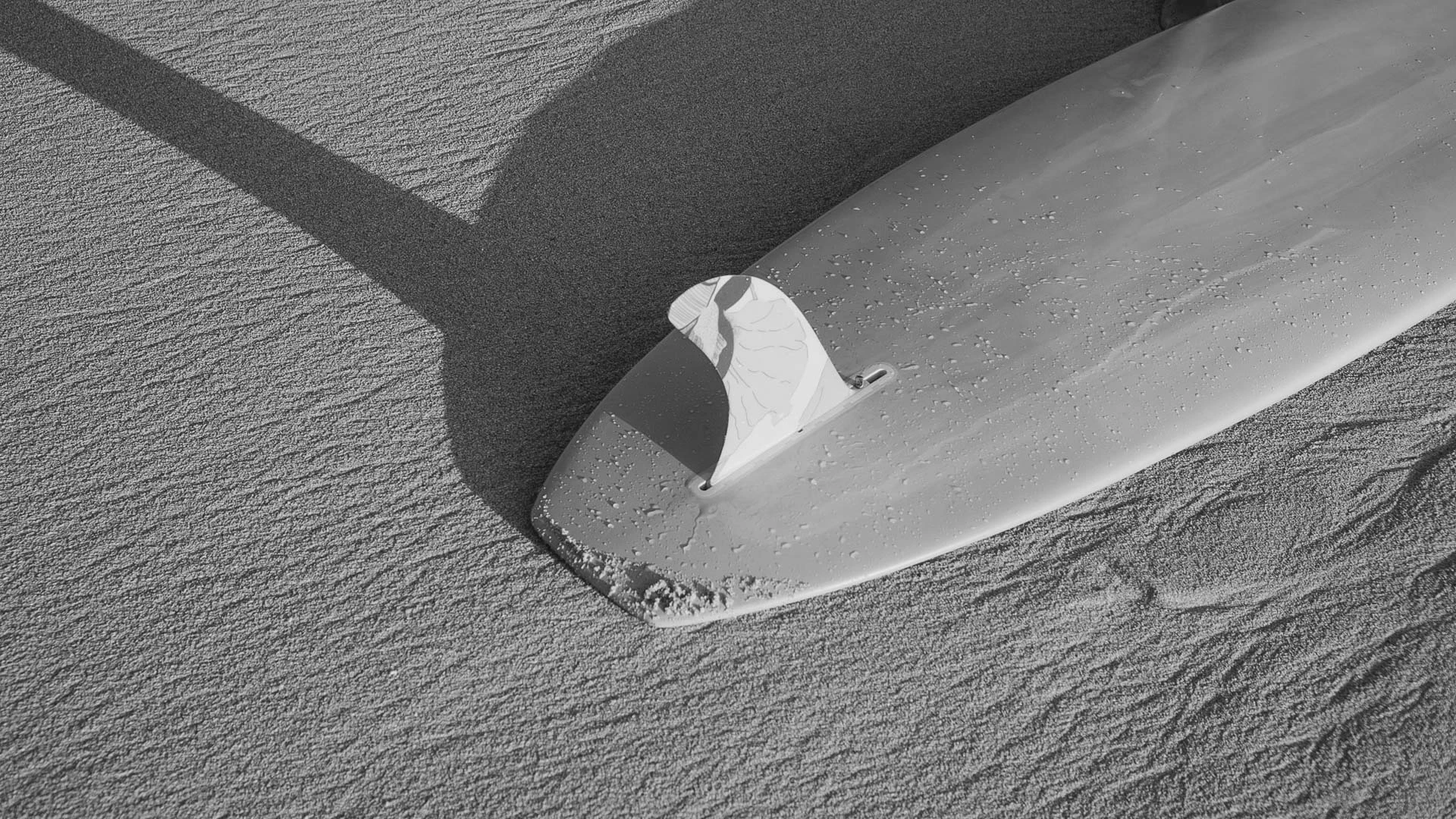 a surfboard on the sand
