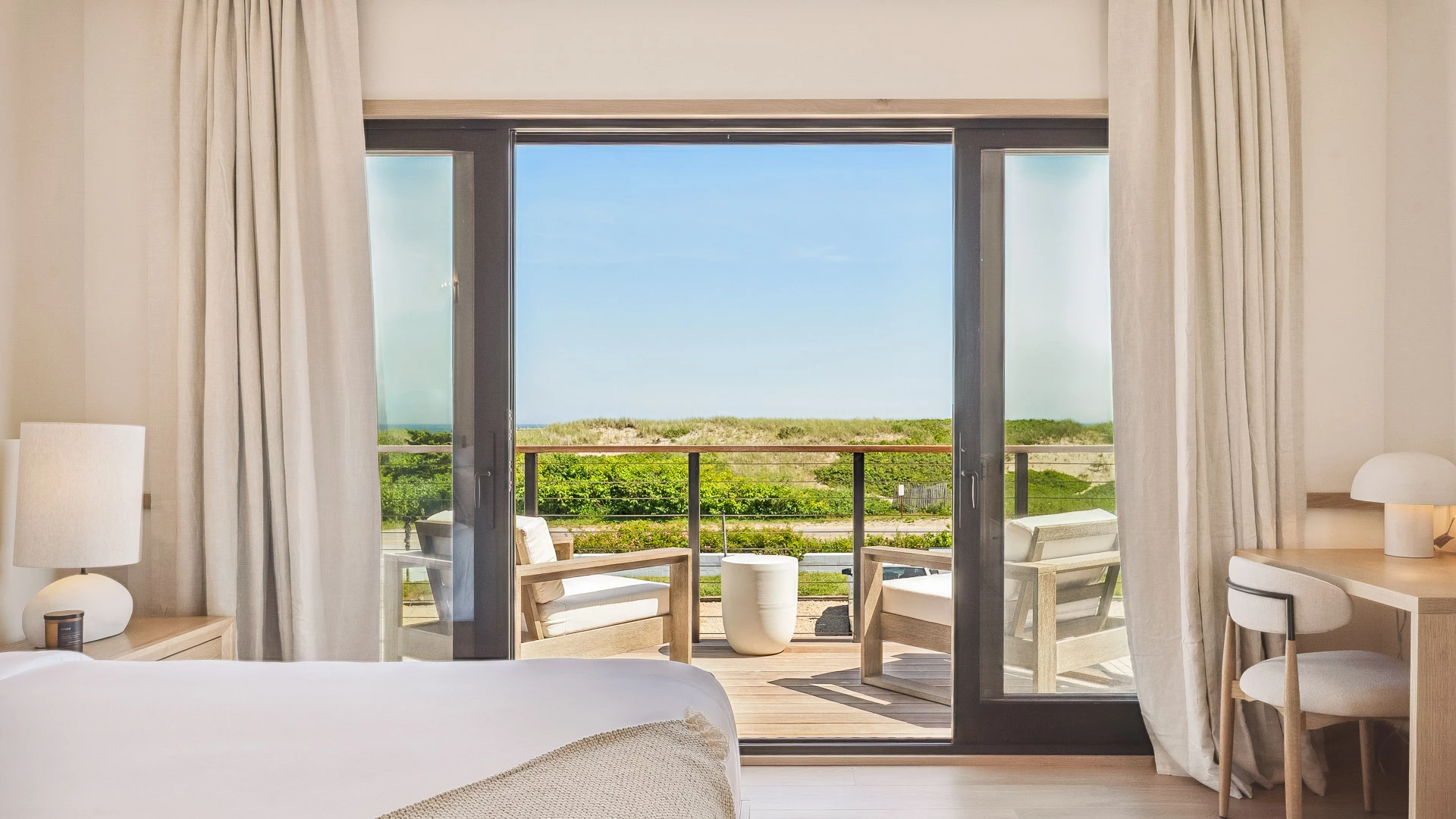 a room with a balcony and chairs