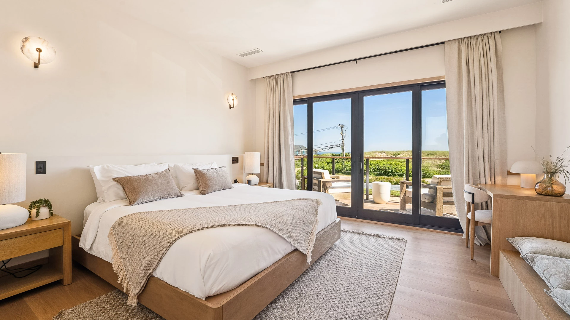 a bedroom with glass doors and a bed