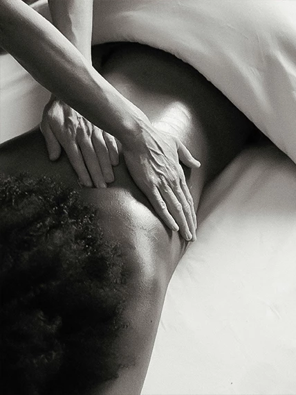 a person's hand on the back of a woman