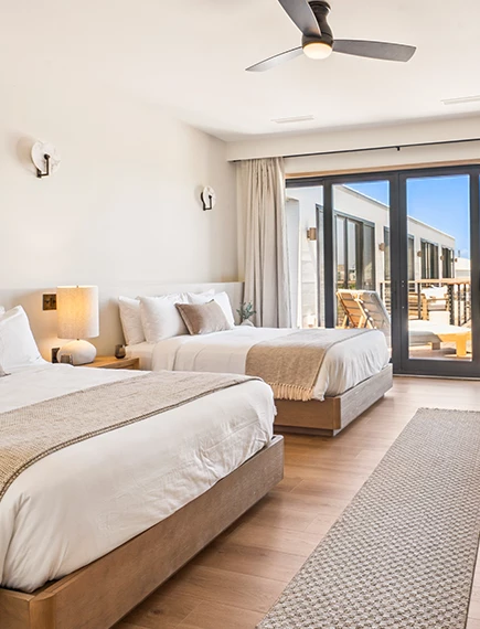 a room with two beds and a glass door