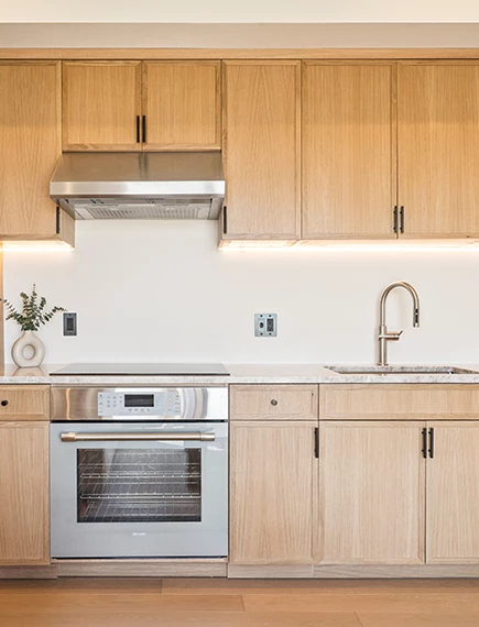 a kitchen with wood cabinets and a sink