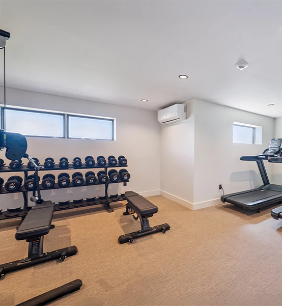 a room with exercise equipment and a window