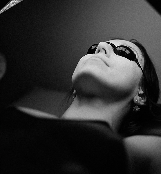 a woman wearing sunglasses and looking up