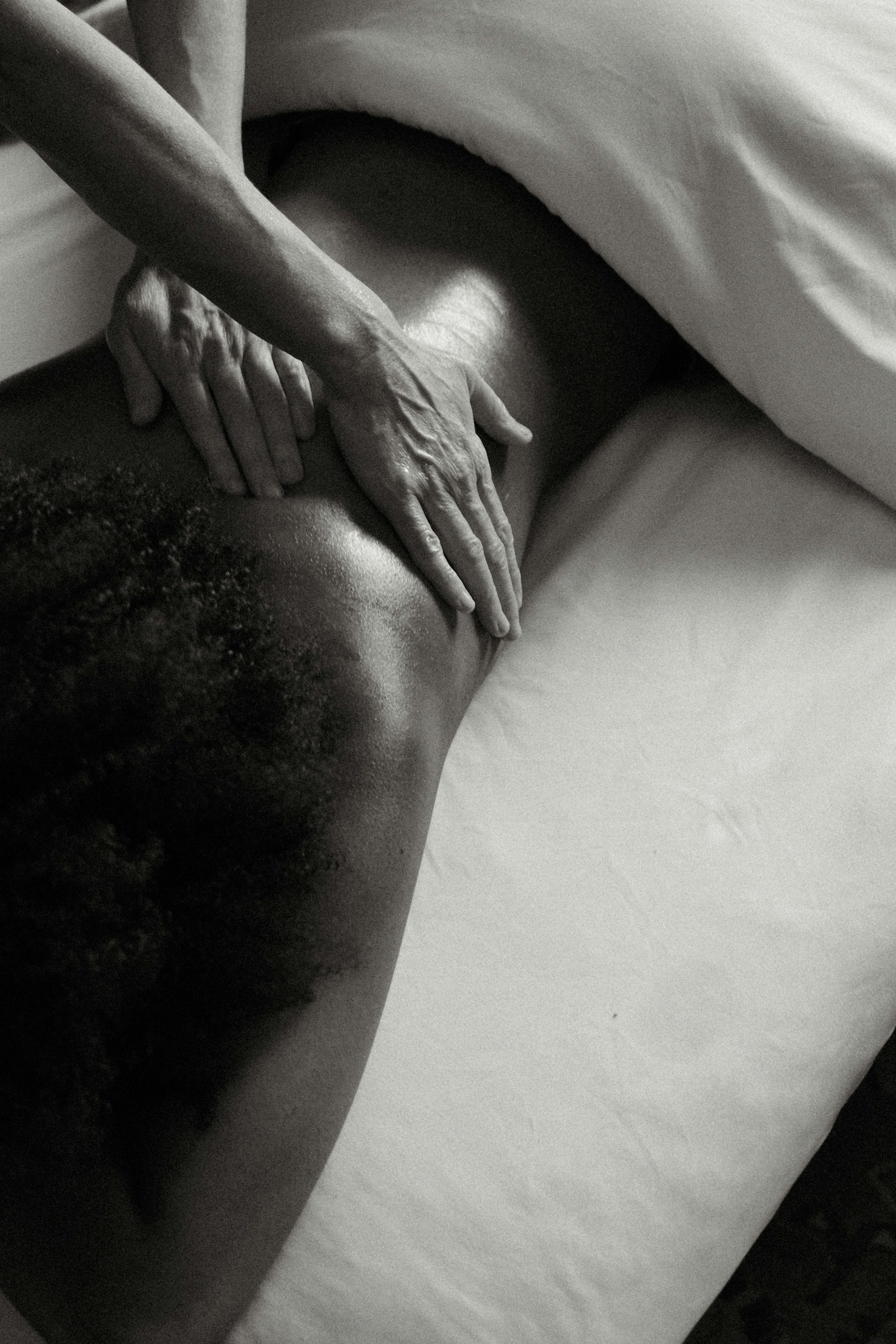 a person's hand on a woman's thigh