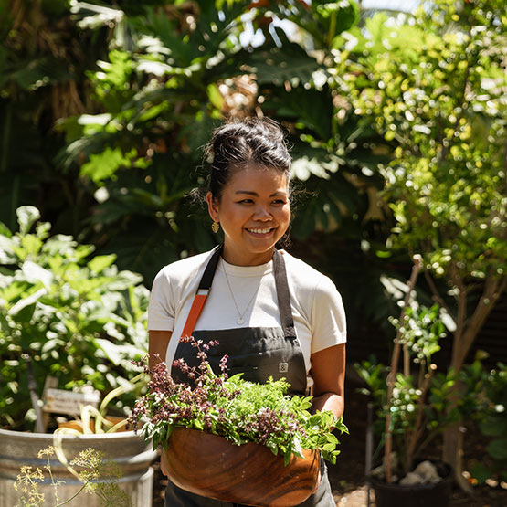 a woman holding a potted plant