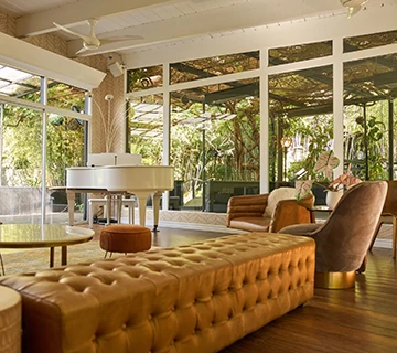 a room with a piano and couches