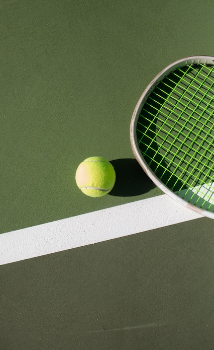 a tennis ball and racket on a court