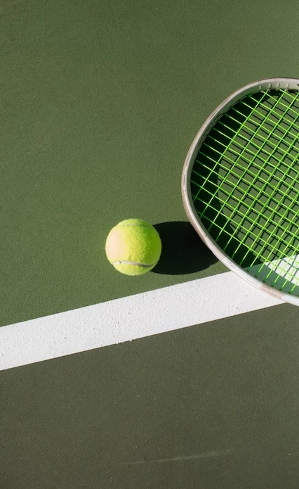 a tennis ball and racket on a court