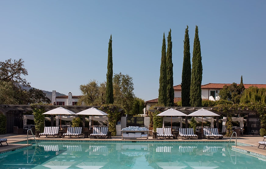 a pool with chairs and umbrellas