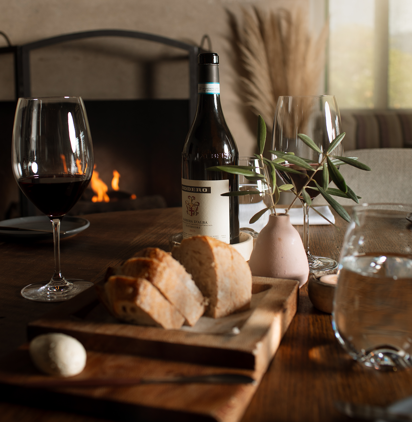a table with wine and bread on it