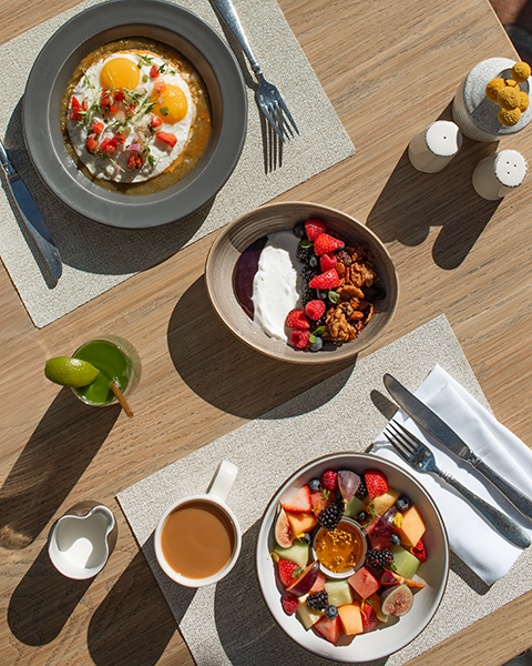 a table with plates of food and drinks