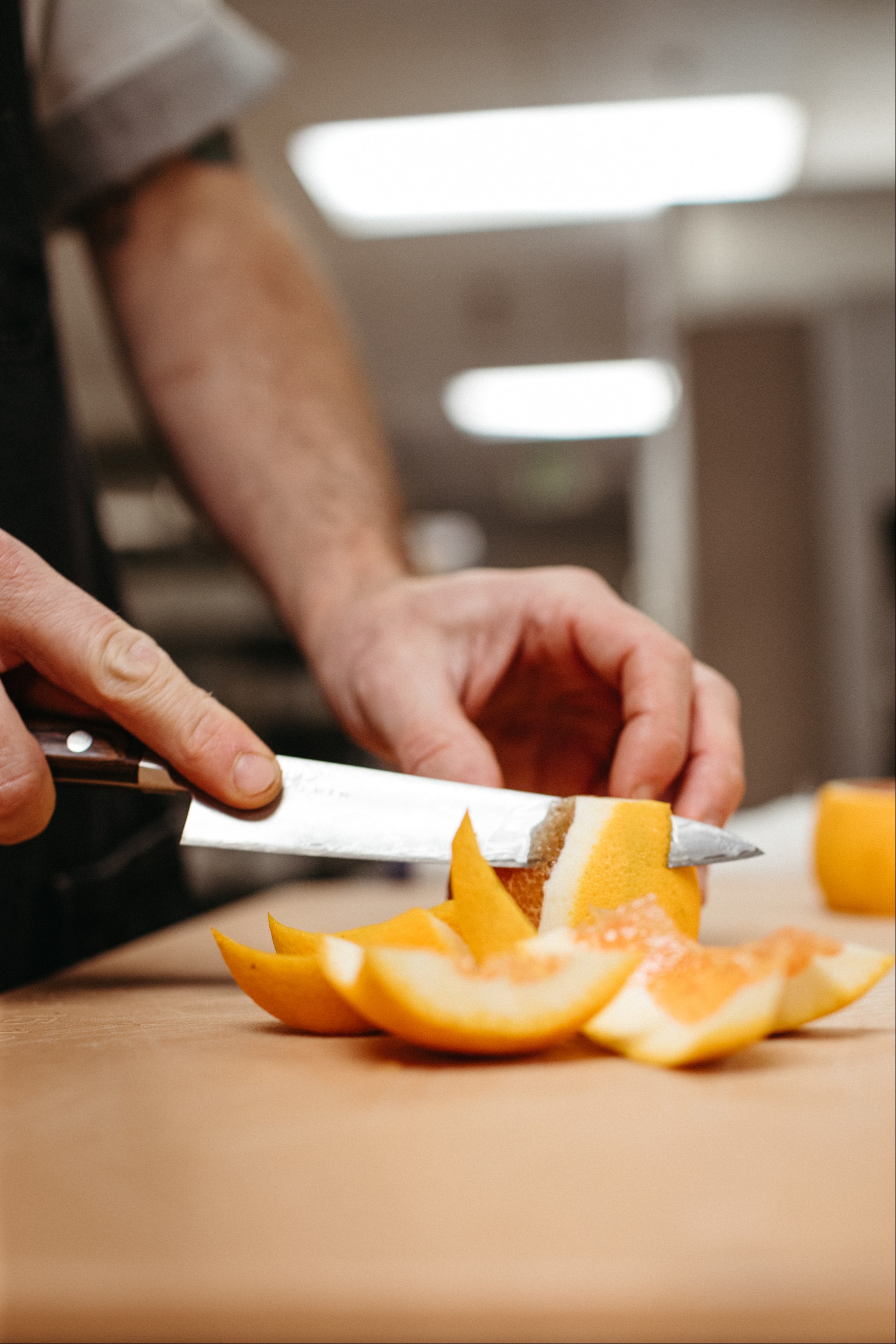 a person cutting an orange