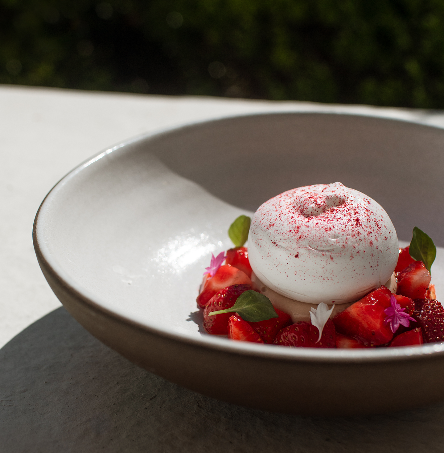 a bowl of food with ice cream and strawberries