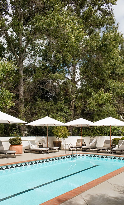 a pool with umbrellas and chairs
