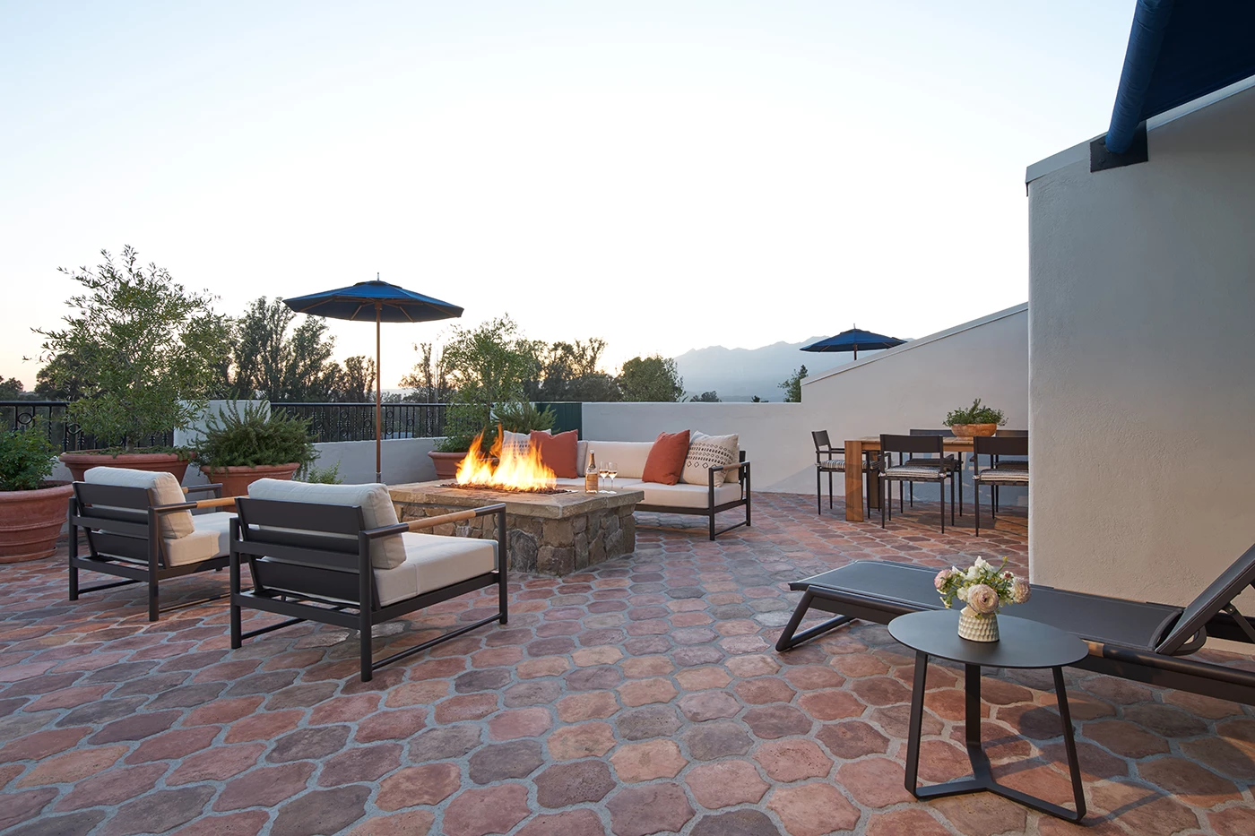 a patio with furniture and a fire pit