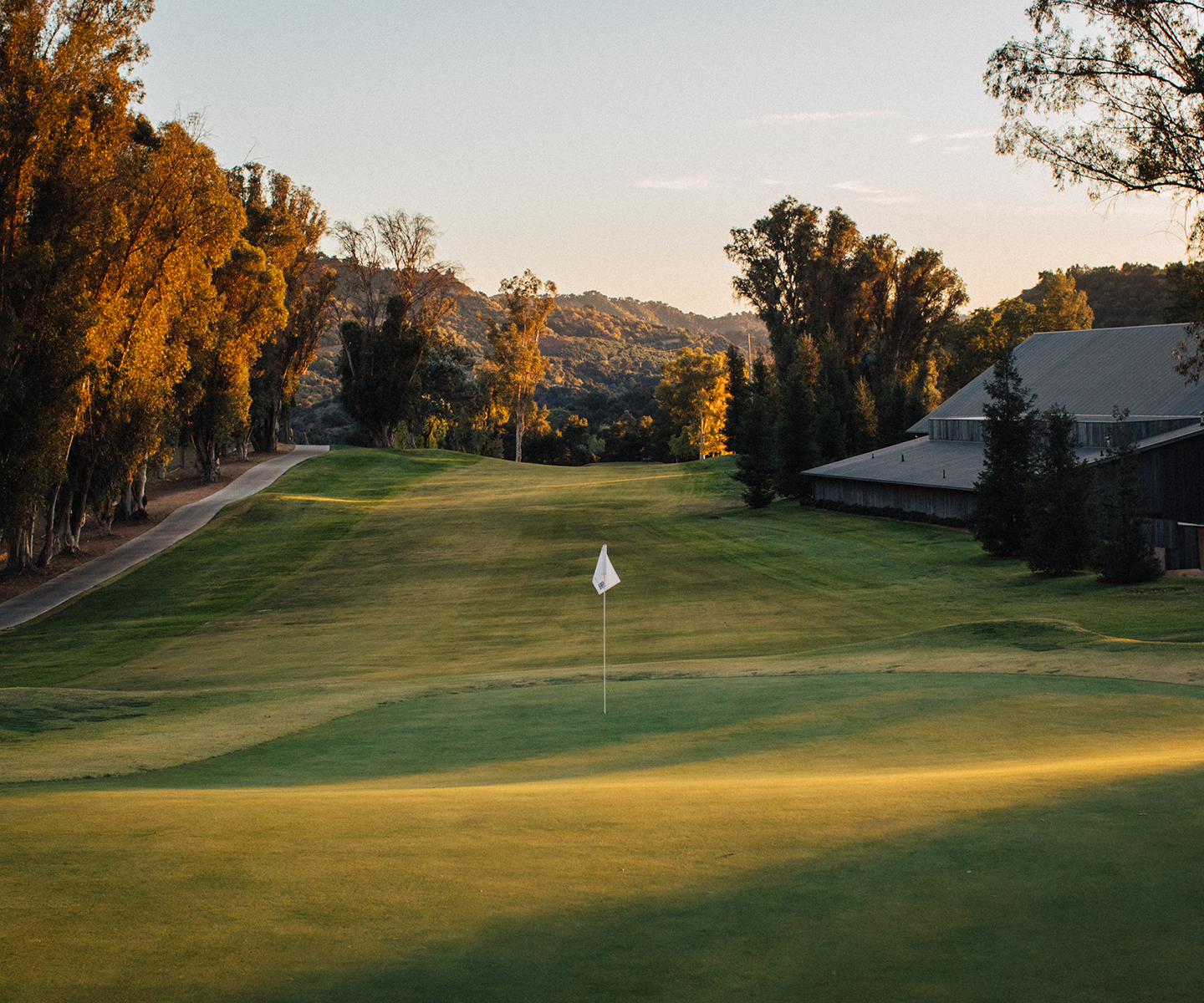 a golf course with a flag on the ground