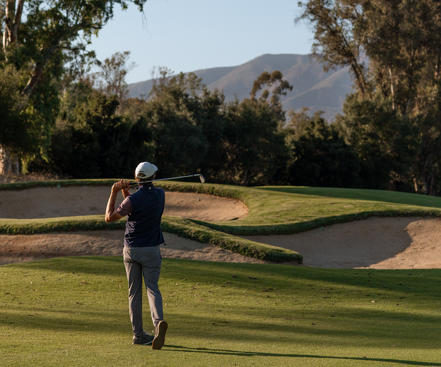 a man playing golf on a golf course