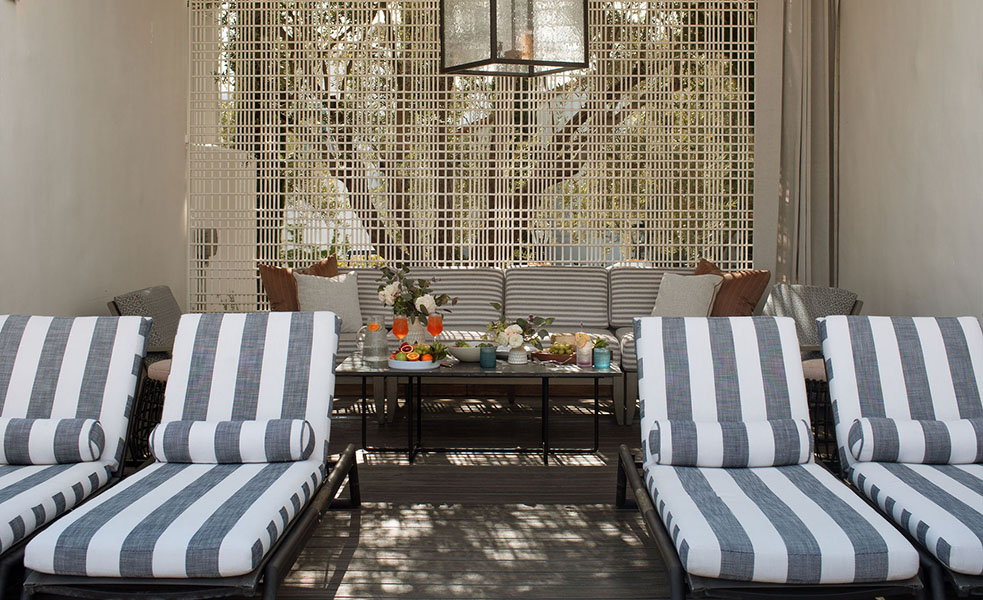 a patio with chairs and a table
