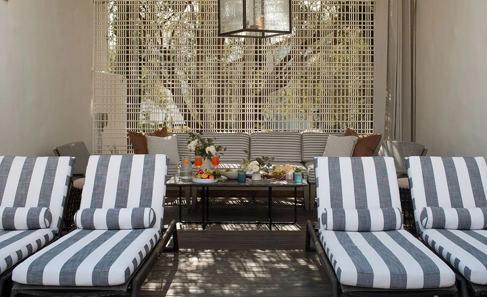 a patio with chairs and a table