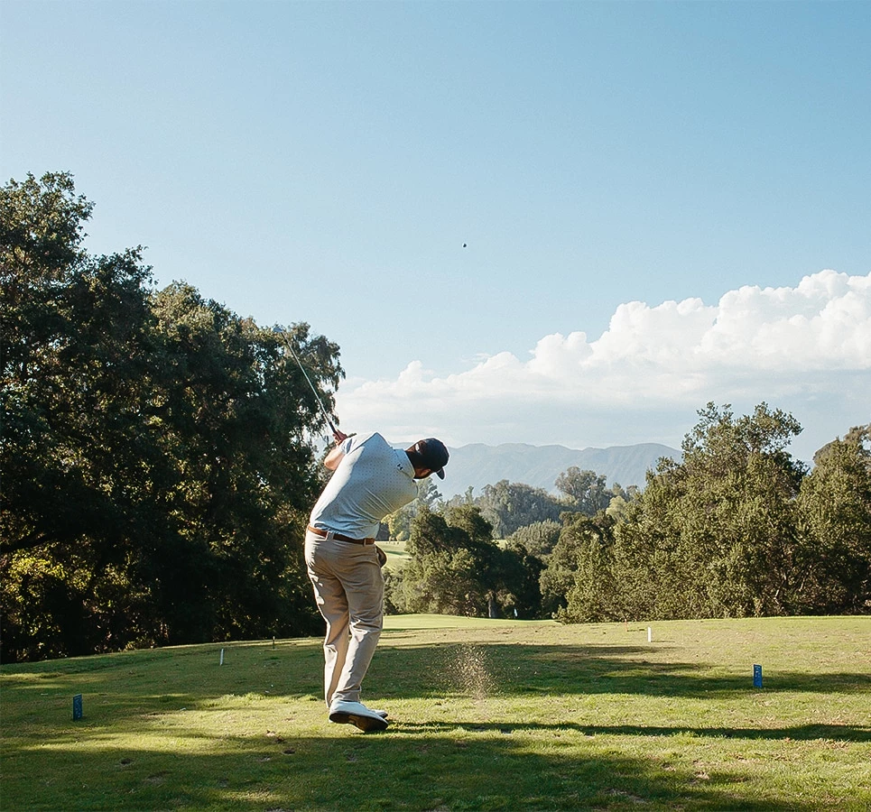 a man swinging a golf club