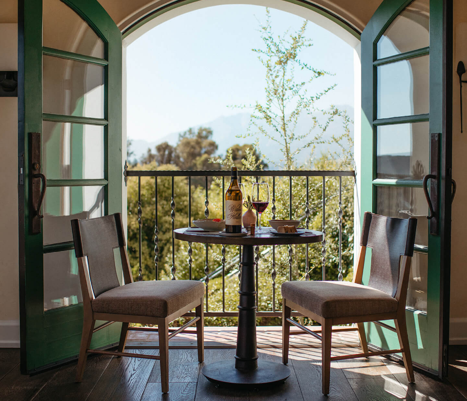 a table and chairs on a balcony