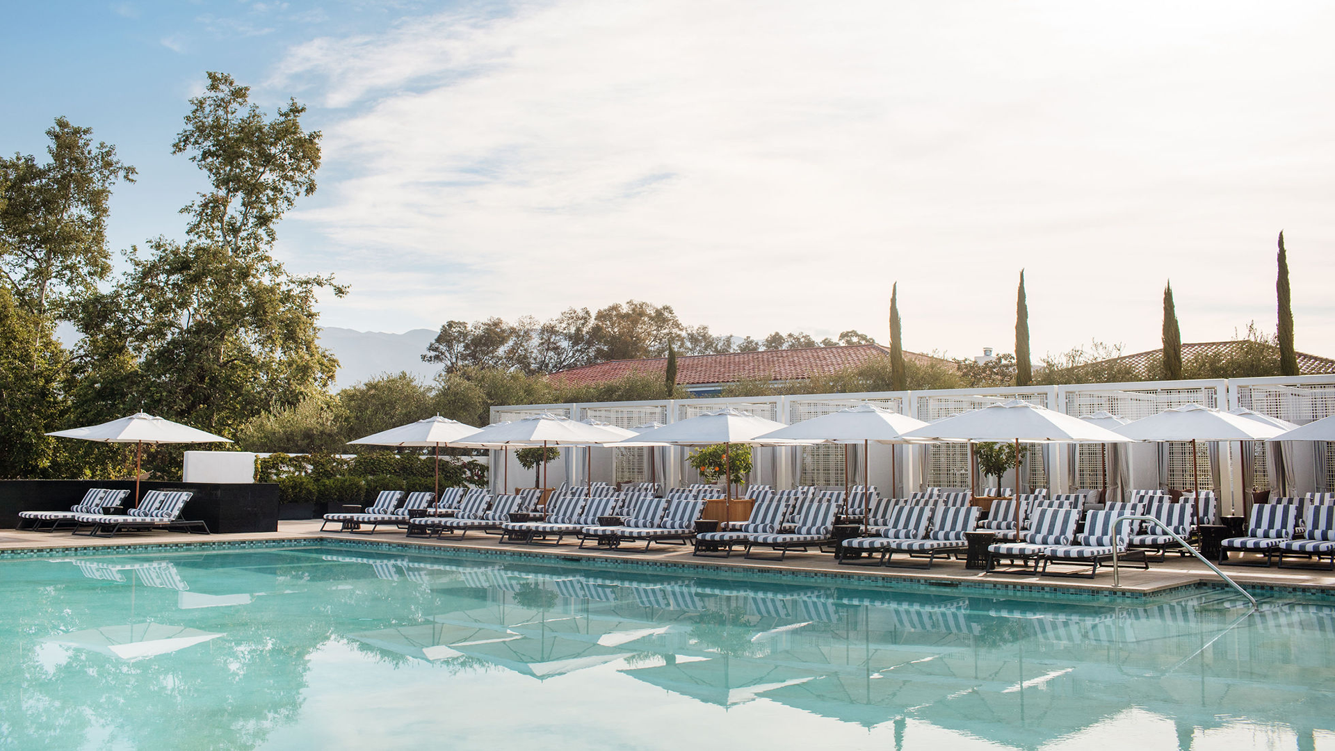 a pool with chairs and umbrellas
