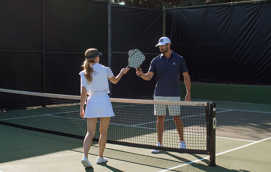 a man and woman holding tennis rackets