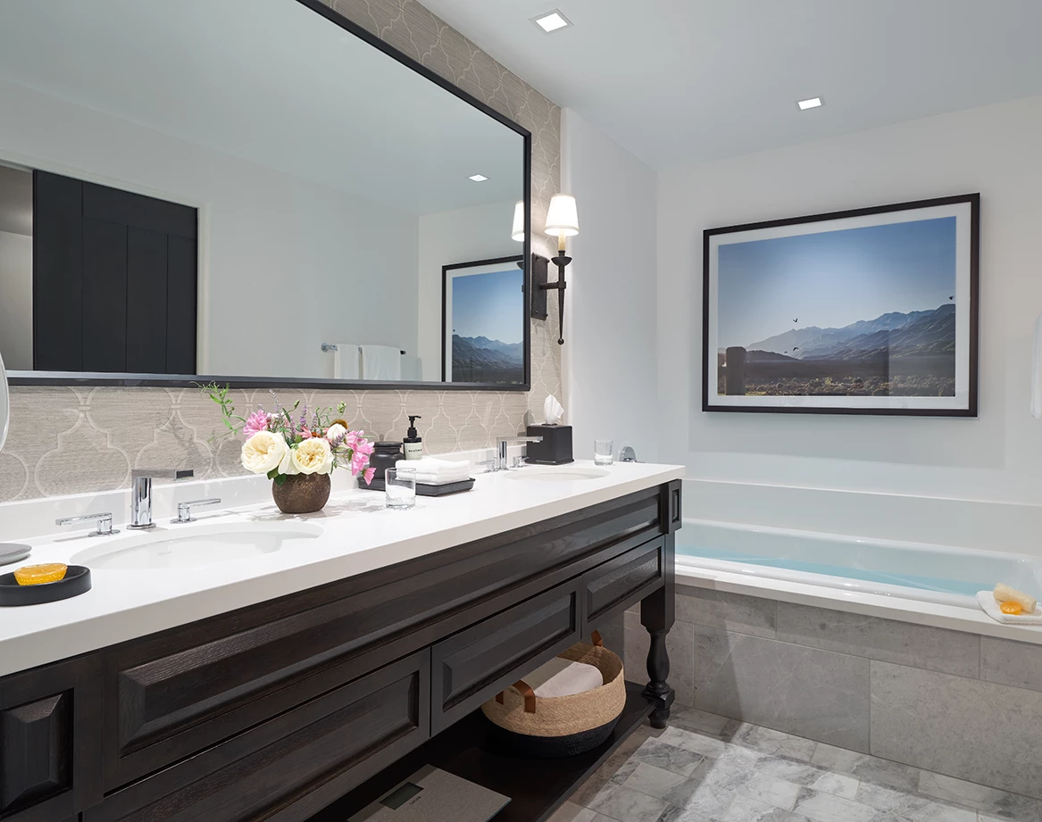 a bathroom with a large mirror and a tub