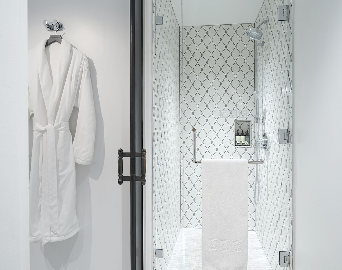 a white bathrobe on a shower