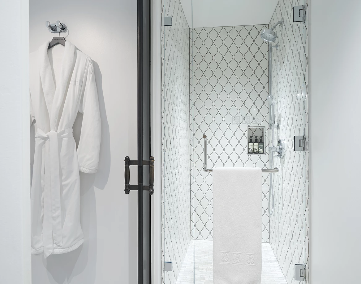 a white bathrobe on a shower