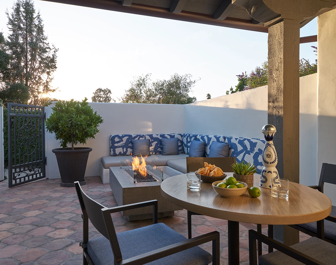a patio with a fire pit and a table