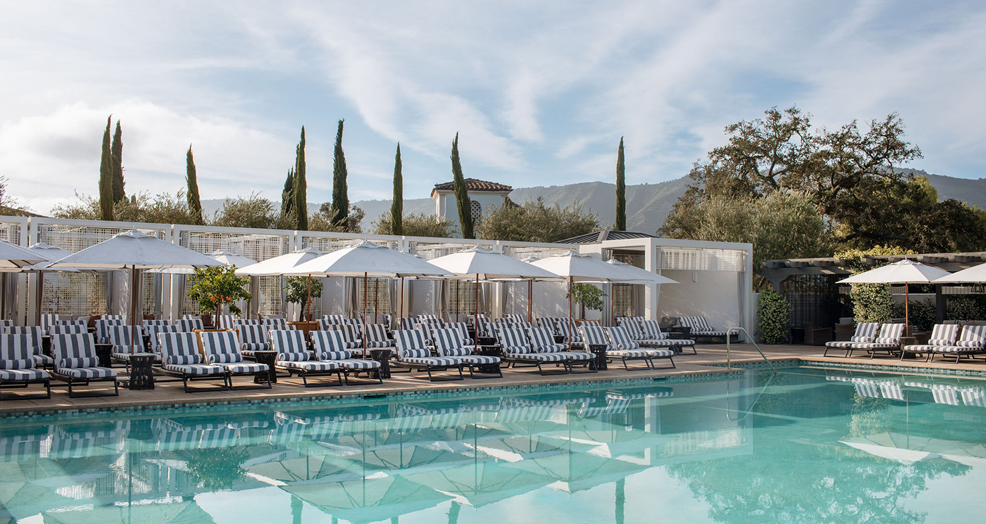 a pool with chairs and umbrellas