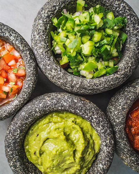a group of bowls of different sauces