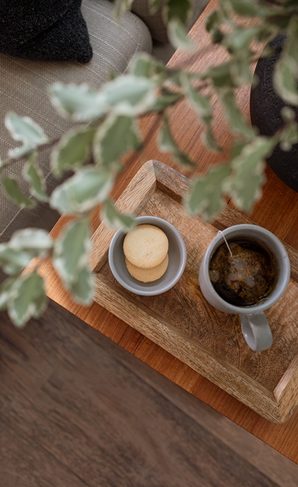 a cup of tea and cookies on a tray