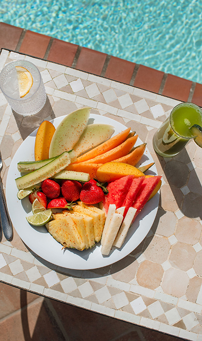 a plate of fruit and a drink