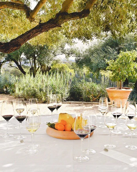 a table with wine glasses and fruit on it