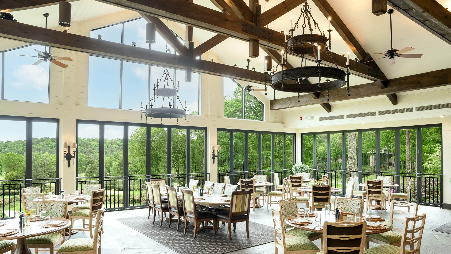 a room with many tables and chairs
