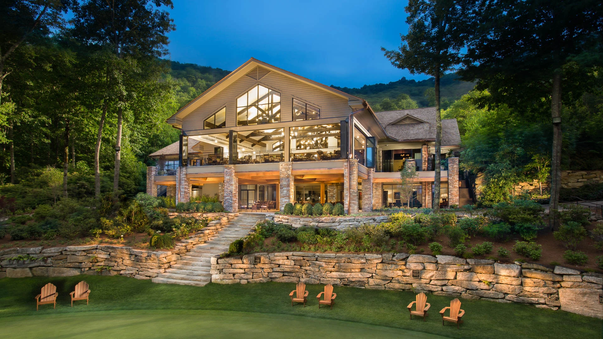 a large house with a lawn and lawn chairs