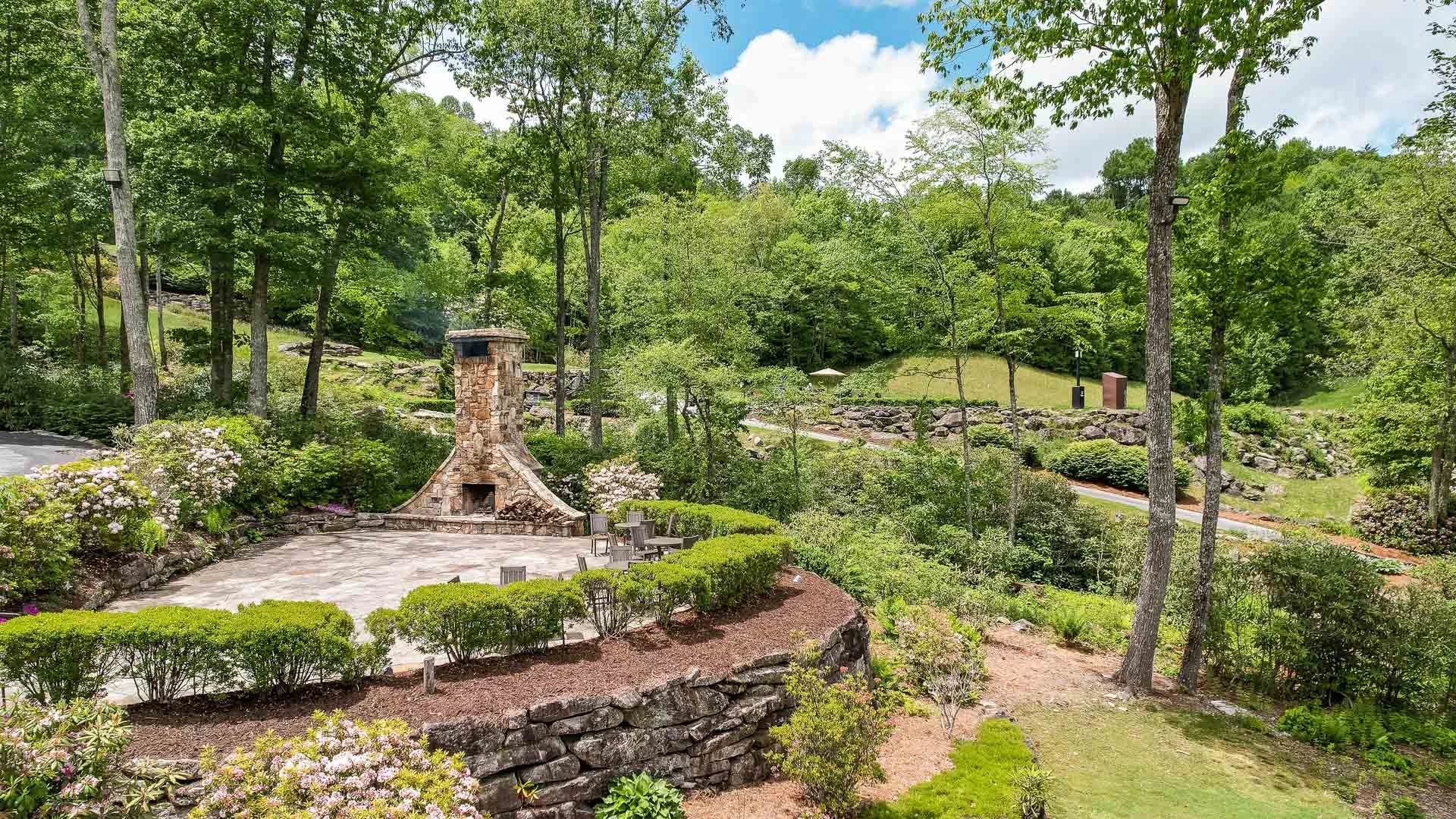 a stone fireplace surrounded by trees