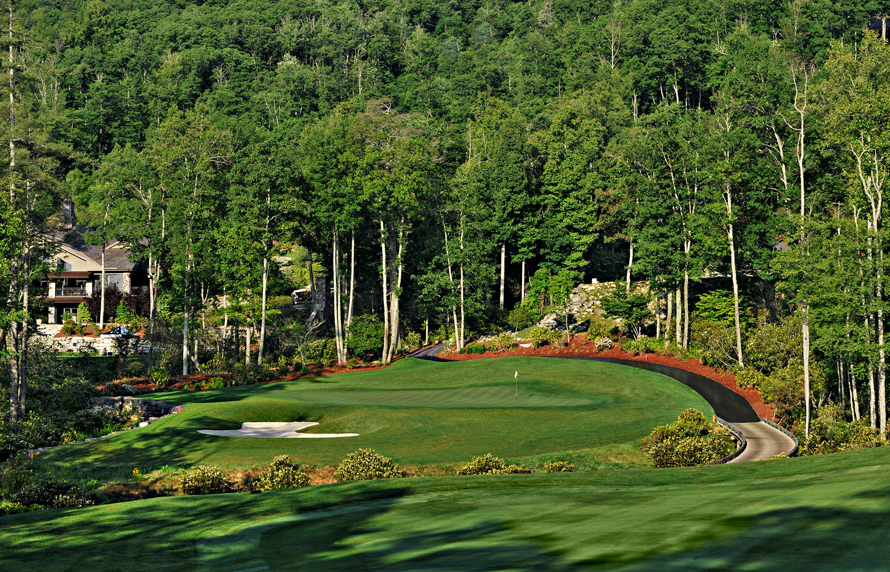 a golf course with trees in the background with Augusta National Golf Club in the background