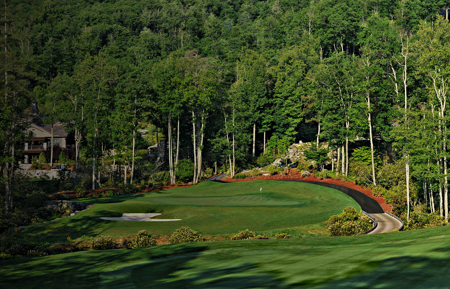 a golf course with trees in the background with Augusta National Golf Club in the background