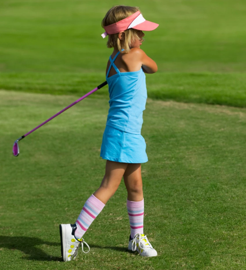 a woman putting on a golf ball